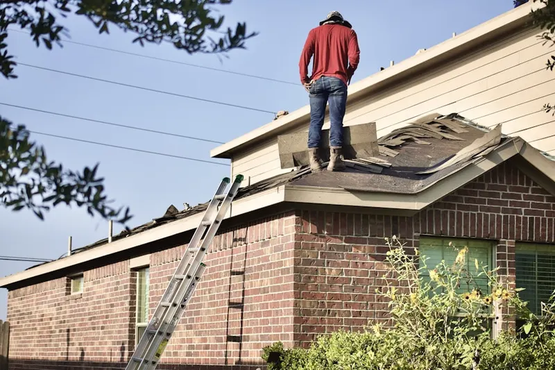 Professional roofer working on a residential roof in Loves Park